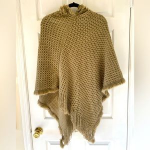 Soft lightweight hooded poncho.  “One size” fits up to standard women’s large.